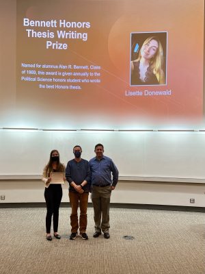 POLS Professors Jeff Dudas and Matt Singer stand with Lissette Donewald, recipient of the Bennett Honors Thesis Writing Prize.